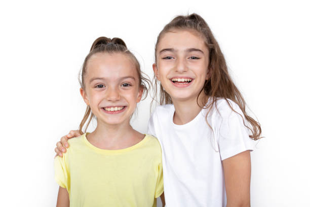 istock Happy little girls hugging each other 1332478673