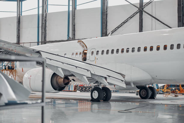 istock Professional plane expluatation service in big hangar 1332479472