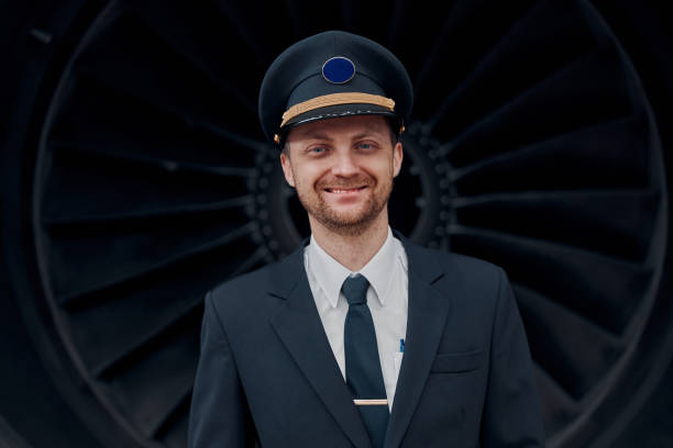 istock profesol confident pilot is checking plane in hangar 1332479493