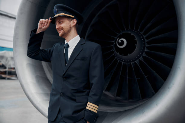 istock profesol confident pilot is checking plane in hangar 1332479495