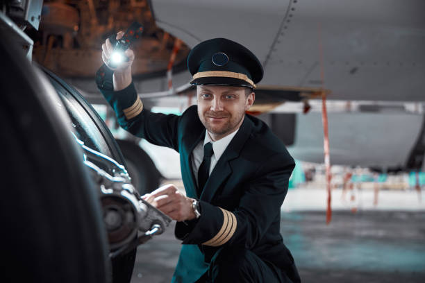 istock profesol confident pilot is checking plane in hangar 1332479501