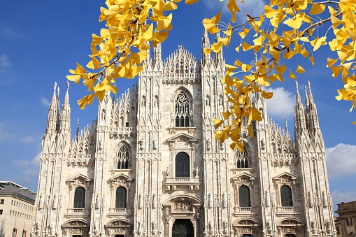 Milan, Italy. Famous landmark - the cathedral made of Candoglia marble.- Autumn leaves - autumn season view.