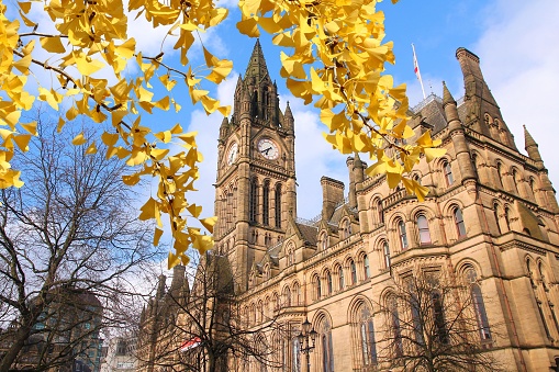 Manchester - city in North West England (UK). City Hall.- Autumn leaves - autumn season view.