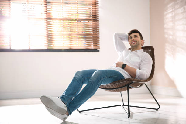 istock Young man relaxing near window at home. Space for text 1332482231