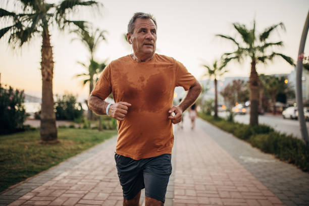 istock Senior man jogging on the sidewalk 1332482450