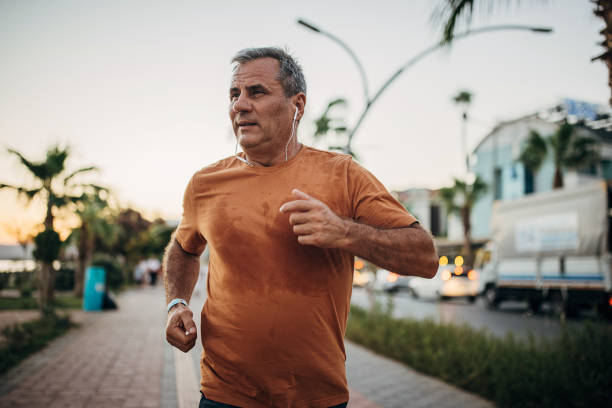 istock Senior man jogging on the sidewalk 1332482601