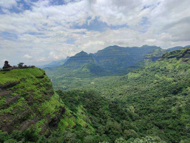 istock Green mountain and blue sky with white clouds 1332483522