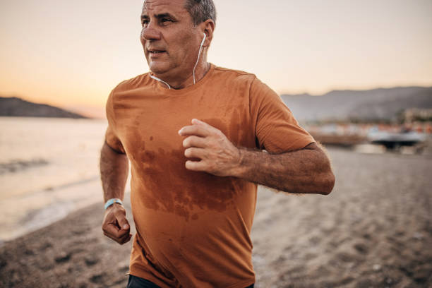 istock Senior male jogging by the sea 1332484206