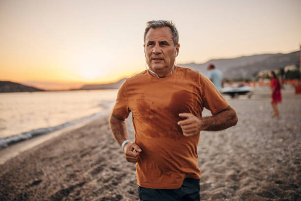 istock Man jogging by the sea 1332484843