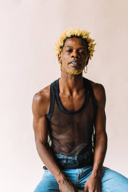 istock Black gay man sitting posing confidently 1332485154