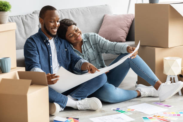 istock Black Spouses Planning Home Renovation, Checking Blueprints And Color Palette 1332485686