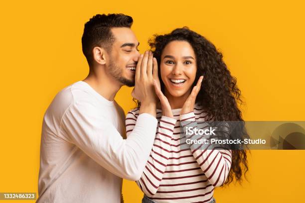 Big Secret Young Arab Man Sharing News With His Excited Girlfriend Stock Photo - Download Image Now