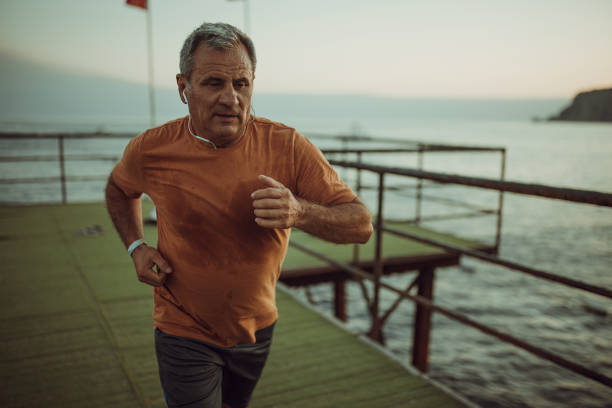 istock Senior male jogging alone on a pier 1332488124