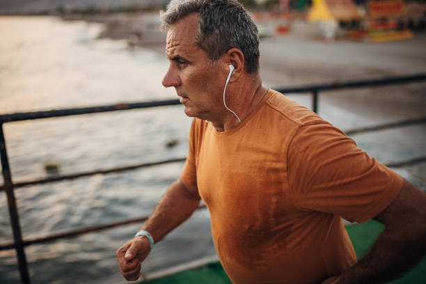 istock Senior male jogging alone on a pier 1332488144
