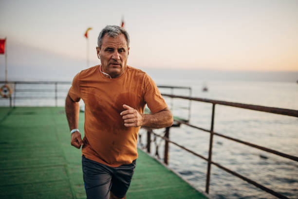 istock Senior male jogging alone on a pier 1332488209