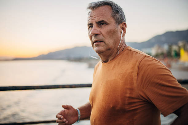 istock Senior male jogging alone on a pier 1332488238