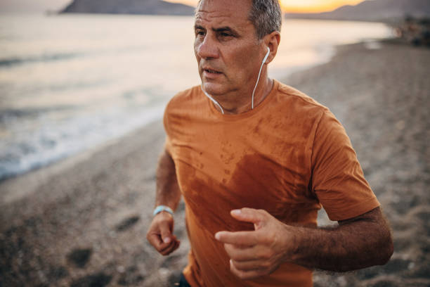 istock Man jogging by the sea 1332488438