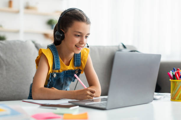 istock Online Edcuation. Girl using laptop, having videocall with teacher 1332488592