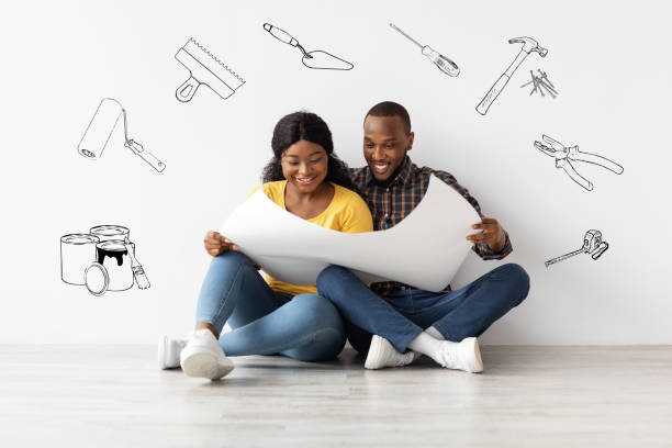 istock Home Renovation Plan. Excited Black Spouses Looking At Blueprints, Creative Collage 1332488628