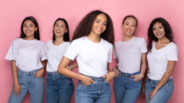 istock African Woman In Front Of Diverse Group Posing In Studio 1332489412