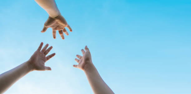 istock image from below looking up the arms, showing victory 1332491025