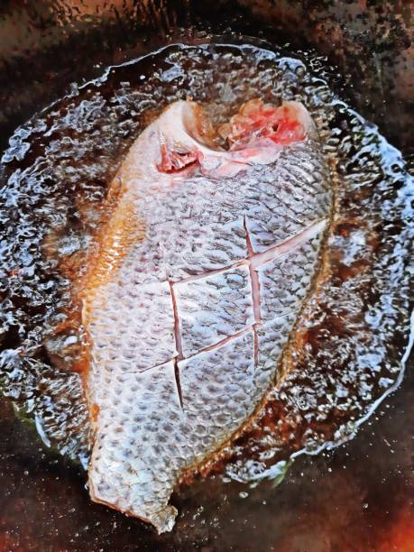 istock Frying Tilapia fish in cooking pan. 1332491042