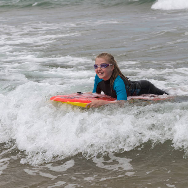 istock A girl rides on her boogie boarder 1332492350