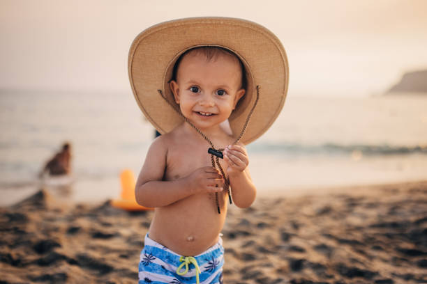 istock A child with a hat on the sea beach 1332496469