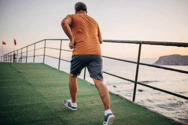 istock Senior male jogging alone on a pier 1332496688