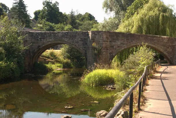 Canongate bridge 16th century arched bridge over Jed Water in summer