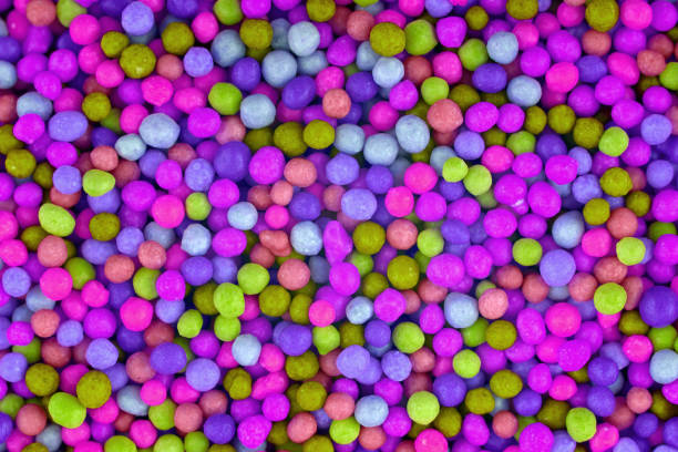 istock Colorful candies background, copy space. Nuts in multi-colored glaze dragee. Sweet candies spreading pastry decoration. Pile of colorful coated candy. Sweets  texture, pattern. Top view, flat lay 1332502175