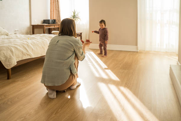 istock Woman stretching hands to her daughter with down syndrome while playing 1332503044