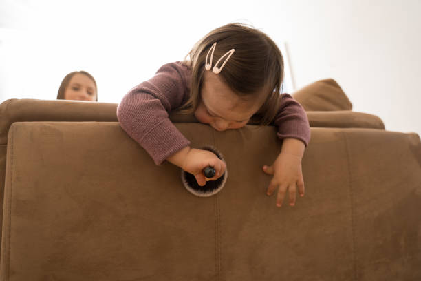 istock Girl with down syndrome playing with makeup brush at the sofa 1332503157