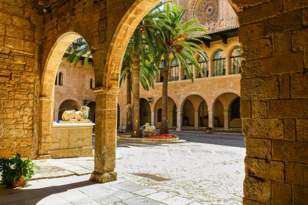 Photo of Interior of the cathedral of Mallorca with patio and stone arches.