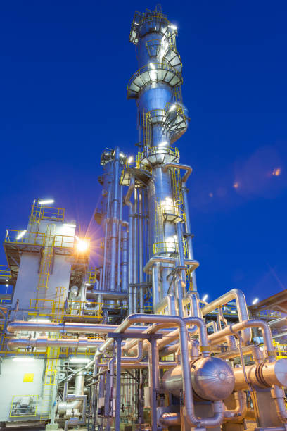 Gas refinery plant View of a gas refinery plant illuminated at dusk. refinery stock pictures, royalty-free photos & images