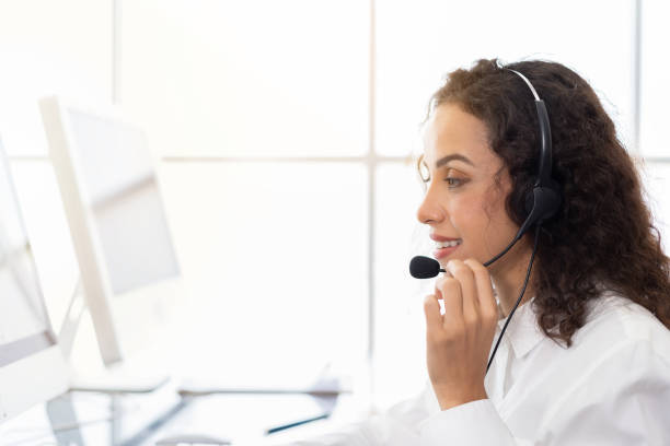 istock Young operator woman working in call center. Woman customer support operator with headset working in the office. Contact center and customer service by headphone concept 1332508576