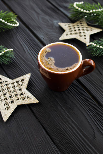istock Coffee cup and Christmas composition on the  black wooden  background 1332508600