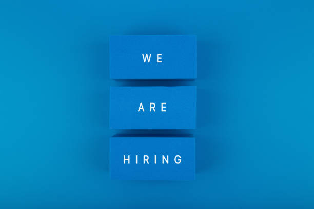 Job opening concept. We are hiring written on blue toy blocks against blue background Trendy job opening concept. Top view with we are hiring text written on three blue toy blocks against blue background with copy space help wanted sign photos stock pictures, royalty-free photos & images