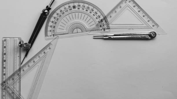 istock Geometric Measuring tools, Drawing items and mathematical instruments placed on white paper sheet. Back to school and Engineering education background. Copy space room for text. 1332509864