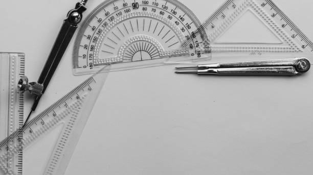 istock Geometric Measuring tools, Drawing items and mathematical instruments placed on white paper sheet. Back to school and Engineering education background. Copy space room for text. 1332509865