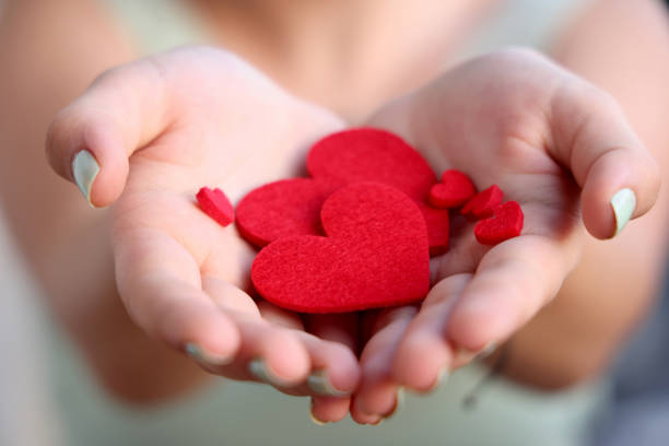 istock Women holding heart shapes 1332510185