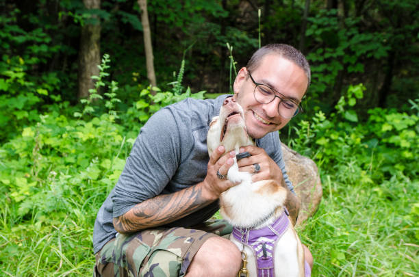 istock Tattooed young man hugging his dog 1332511692