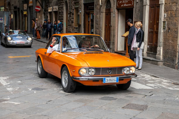 Florence, Italy - May 7, 2010: Lancia Fulvia in the rally Mille Miglia 2010 edition on a busy street in Florence. Florence, Italy - May 7, 2010: Lancia Fulvia in the rally Mille Miglia 2010 edition on a busy street in Florence. 2010 stock pictures, royalty-free photos & images