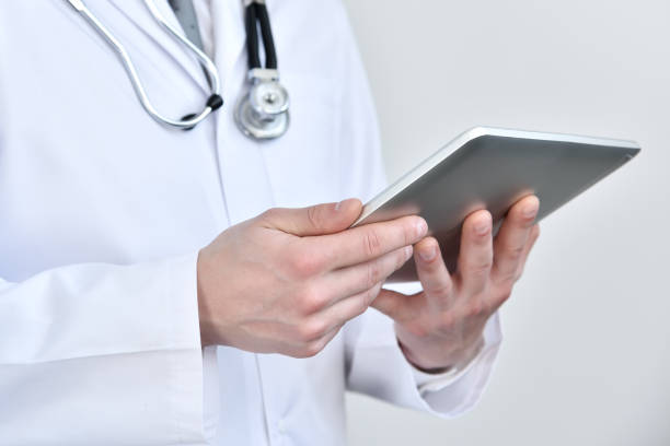 istock Doctor holding touch pad computer in hand. 1332512511