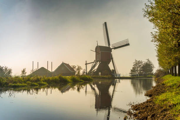 dutch  scene with fog and windmill,sunrise - polder windmill space landscape imagens e fotografias de stock