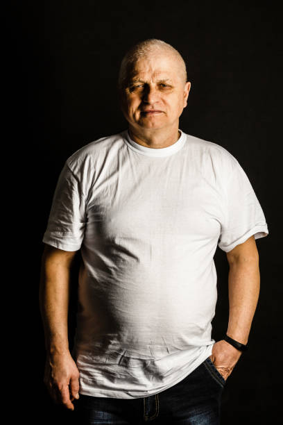 istock Portrait of an elderly man on black background 1332514071