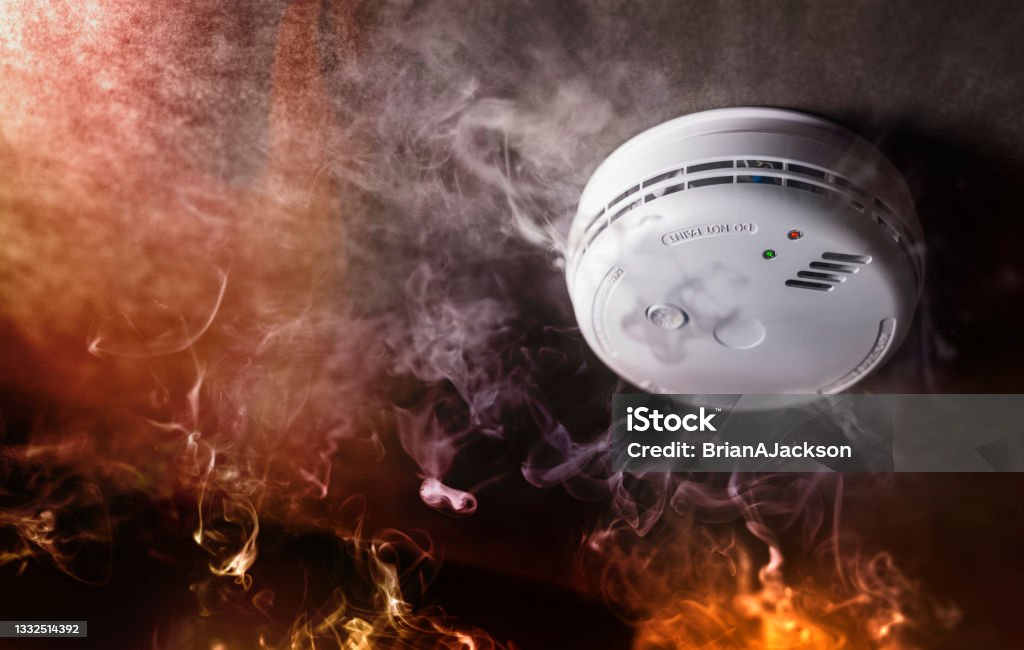 Smoke detector and fire alarm in action background Smoke detector and fire alarm in action background with copy space Fire - Natural Phenomenon Stock Photo