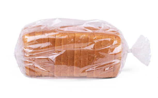 Sliced white bread in plastic bag isolated on white background Sliced white bread in plastic bag isolated on white background. loaf of bread stock pictures, royalty-free photos & images