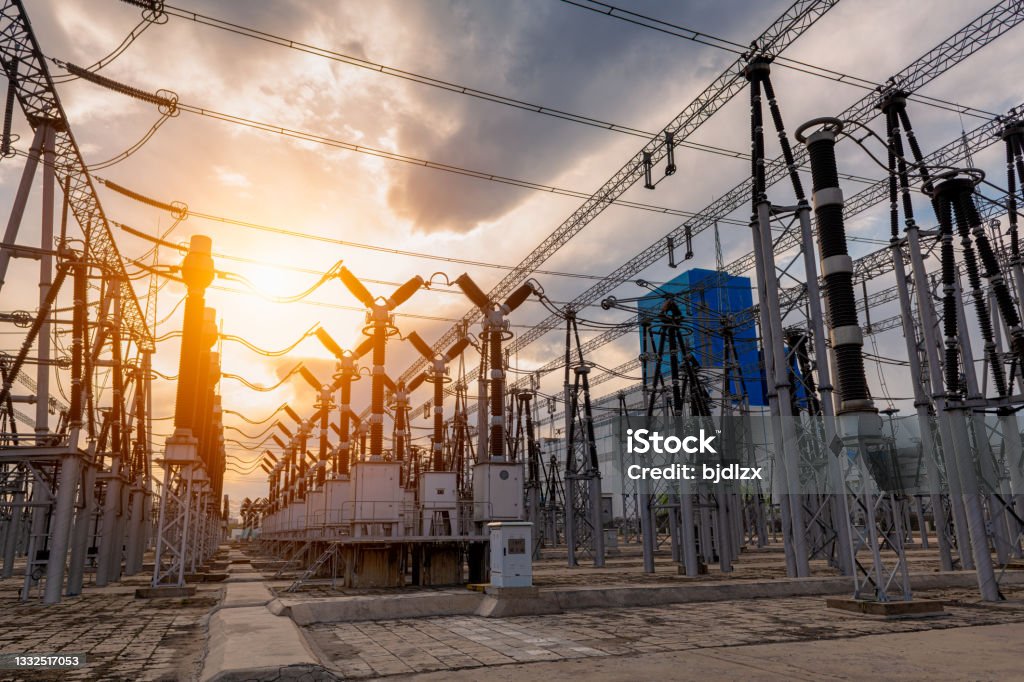 High voltage substation under sunset Electricity Substation Stock Photo