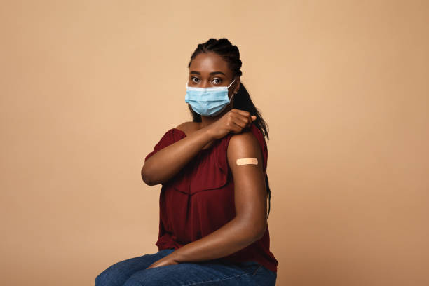 istock African american woman with face mask after immunization 1332517982